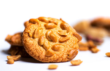 Group of cookies with peanuts on mat.