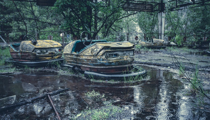 Broken metal radioactive cars in amusement park in the city of Pripyat, the Chernobyl disaster, Ukraine