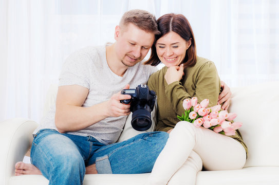 Happy family couple reviewing nicely taken photos