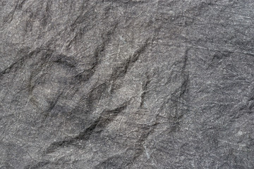 Crumpled fabric texture, dark gray cloth background. Copy space