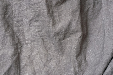 Crumpled fabric texture, dark gray cloth background. Copy space