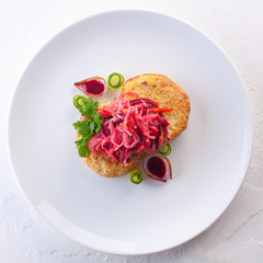 potato pancakes with vegetable salad and herbs