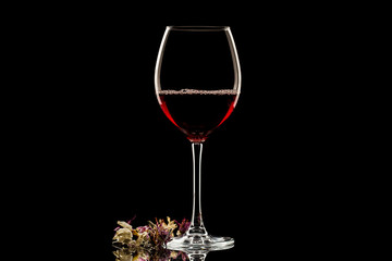 a glass of wine on dark background