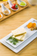 Fototapeta na wymiar Feta sheep cheese on white plate with olive