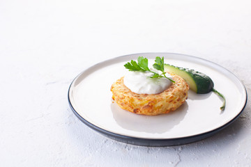 potato pancakes with sour cream , fresh cucumber and herbs