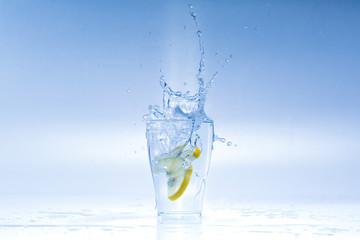Lemon splashes in a water glass