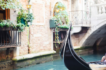 Fototapeta na wymiar Gondola boat in Venice. Venetian canal with blue water. Empty streets in Italy. Italian old town. Beautiful ancient architecture with stone houses. Closed-down cities. Close up. Copy space.