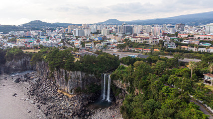 Aerial View of The High Waterfall Jeongbang and Lagoon at Seoqwipo on Jeju Island