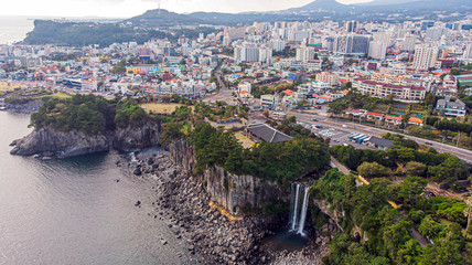 Aerial View of The High Waterfall Jeongbang and Lagoon at Seoqwipo on Jeju Island