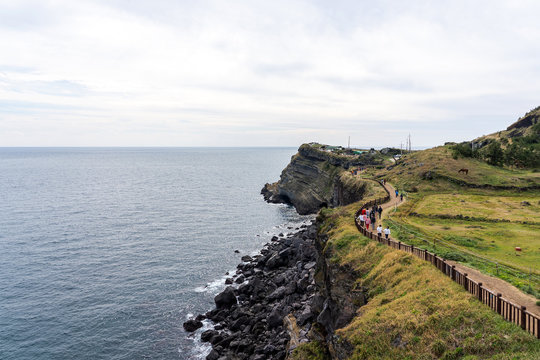 People Walking along the Coast