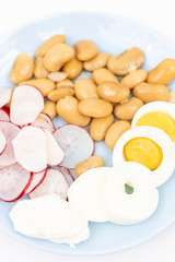 Salad with sliced boiled eggs, cooked beans, sliced radishes and sour cream