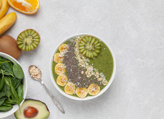 Healthy Breakfast smoothie bowl with avocado, spinach, kiwi, spinach and Chia seeds.