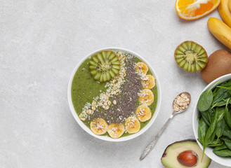 Healthy Breakfast smoothie bowl with avocado, spinach, kiwi, spinach and Chia seeds.