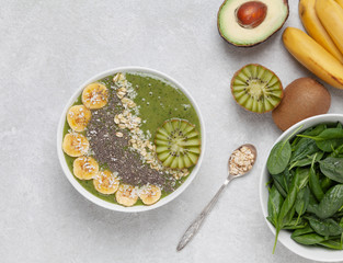 Healthy Breakfast smoothie bowl with avocado, spinach, kiwi, spinach and Chia seeds.