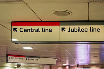 Direction tables with arrows pointing to Central and Jubilee line in London underground station
