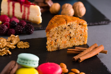 cinnamon and carrot cake on black plate