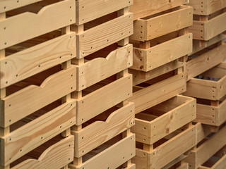 Empty wooden boxes or containers for fruit and vegetables stacked in warehouse