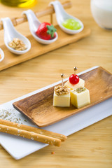 Delicious canape with dill herb and tomato.Canapes on white ceramic plate.