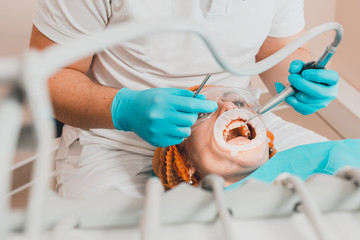 The patient visits the dentist regarding the procedure of ultrasonic cleaning of teeth in dentistry.