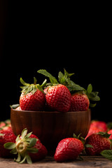 Fresh strawberry in basket on wooden rustic table