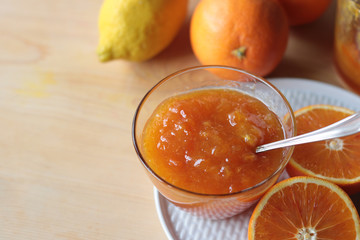 close up of orange jam in a glass bowl