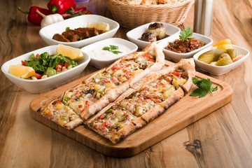 Turkish vegetable pide on wooden table