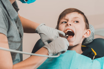orthodontist inspects teenager's oral cavity with a dental camera