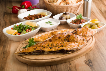 closed mince turkish pide on wooden table