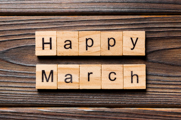 Happy March word written on wood block. Happy March text on table, concept