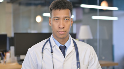 Portrait of Young Doctor Looking at Camera in Office