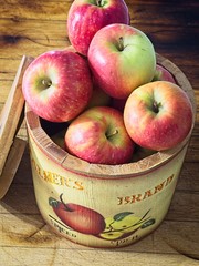 small red apples in basket