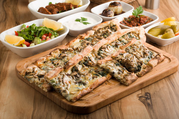 turkish mushroom pide on wooden table