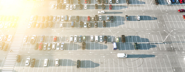 Cars on a market parking view from above at sunset