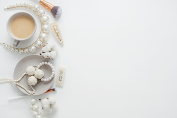 Wedding background, decorated with decorations for the bride's dress, white feather, cotton flower, pearl hairpins, around the text space, all in pastel colors. Concept preparation for the wedding