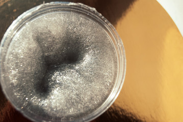 slime transparent elastic glitter slice in the bank in the hand background