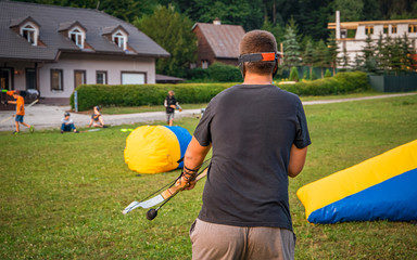 Young man preparing for an attack while playing archery tag