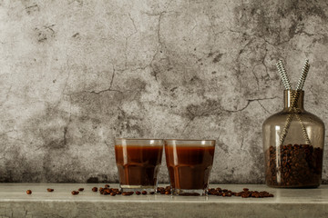 Iced coffee with milk on a dark background. Coffee with ice and cream on a gray background close-up.