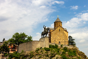 Fototapeta na wymiar The Metekhi Virgin Mary Assumption Church and statue of King Vakhtang Gorgasali overlook the east bank of the Kura river in Tbilisi, Georgia