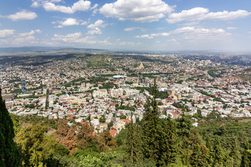 Fototapeta na wymiar Cityscape of Tbilisi, Georgia as viewed from Mtatsminda View Point. The Holy Trinity Cathedral of Tbilisi is a prominent landmark.