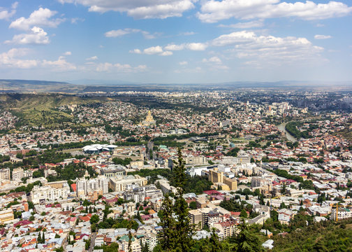 Cityscape of Tbilisi, Georgia as viewed from Mtatsminda View Point. The Holy Trinity Cathedral of Tbilisi is a prominent landmark.