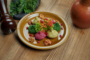 Pkhali in ceramic plate. Copy space. Traditional Georgian appetizer Pkhali made of chopped and minced cabbage, eggplant, spinach, beans, beets and combined with walnuts, garlic, and herbs