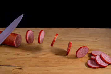 cut bit of the sausage fly away from knife