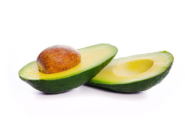 Two fresh slices of avocado with core isolated on a white background in close-up. 