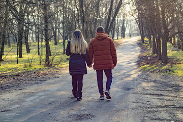 lad and girl walk on park
