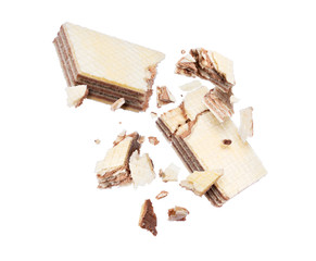 Chocolate waffles crushed into pieces in the air on a white background