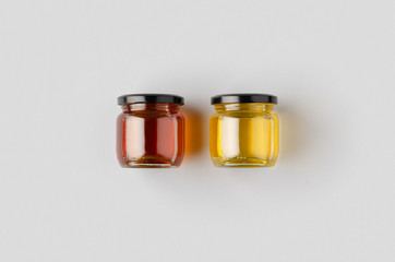 Honey jars mockup on a grey background. Two different colors.