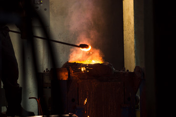 The molten liquid metal is poured into the mold.