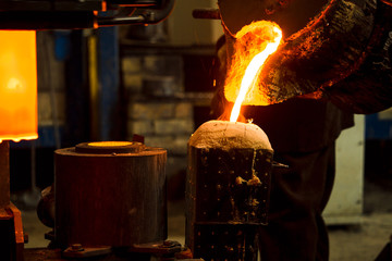 The molten liquid metal is poured into the mold.