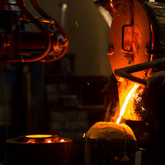 The molten liquid metal is poured into the mold.