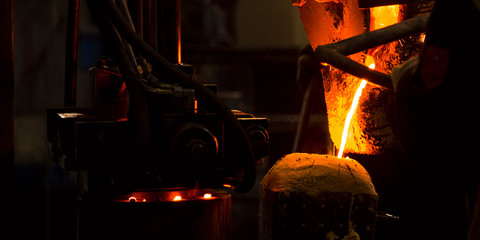 The molten liquid metal is poured into the mold.